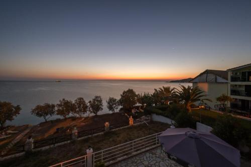 a view of the ocean at sunset from a hotel at Laura Beach House in Alykes