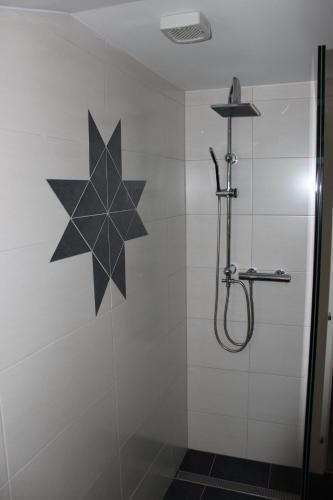 a shower stall with a black star on the wall at Panoramablick Osttirol in Lienz