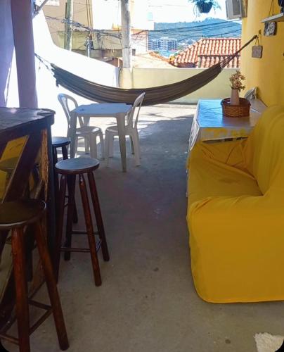 a living room with a hammock and a table and chairs at Para sua diversao! in Arraial do Cabo