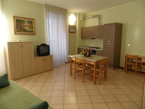 a kitchen and dining room with a table and chairs at Casa Vacanze Touring in Verbania