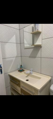 a bathroom with a white sink and a mirror at Pousada da vila in Abelardo Luz