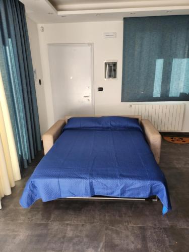 a bedroom with a blue bed with a blue blanket at Villa Luigi in Valverde