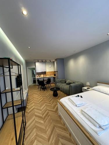 a bedroom with a bed and a living room at The Best Shkoder in Shkodër