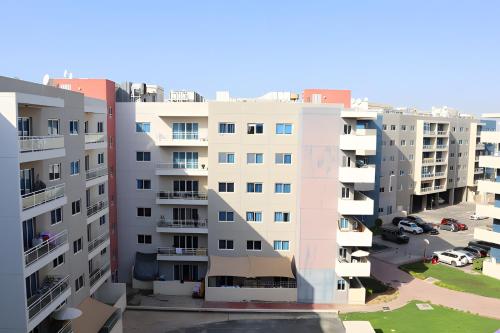 an aerial view of some apartment buildings at Peaceful Al Reef Studio - King Bed Comfort for 2 Near Community Park in Abu Dhabi
