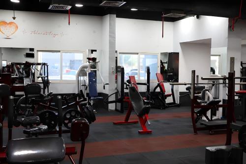 a gym with lots of treadmills and machines at Peaceful Al Reef Studio - King Bed Comfort for 2 Near Community Park in Abu Dhabi