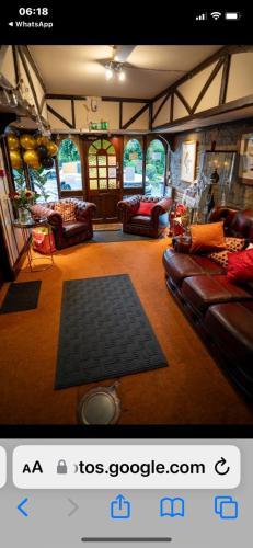 a living room with couches and a rug at The Lane Head Hotel in Brighouse