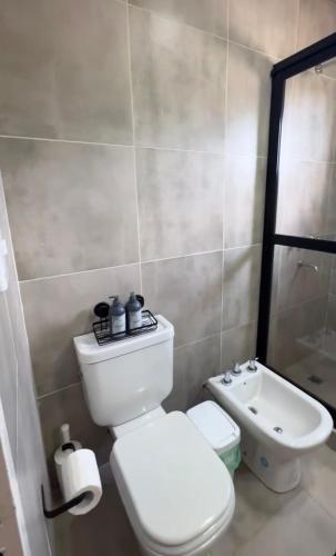 a bathroom with a white toilet and a sink at Cerros de Cafayate, Casa Nº1 in Cafayate