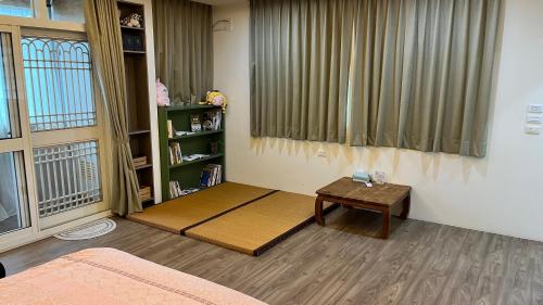 a living room with a table and a window at Jia's Homestay in Lugu