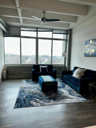 a living room with a couch and a rug at Piedmont Perch in Atlanta
