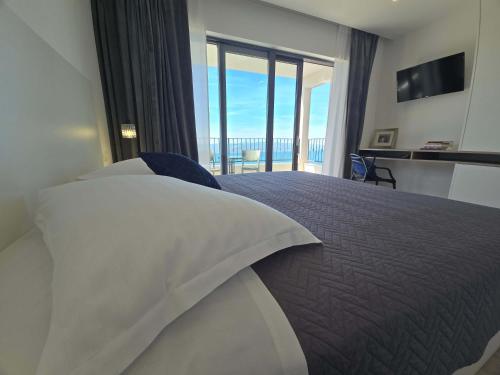 a bedroom with a bed with a view of the ocean at Villa Adria Horizon in Bast