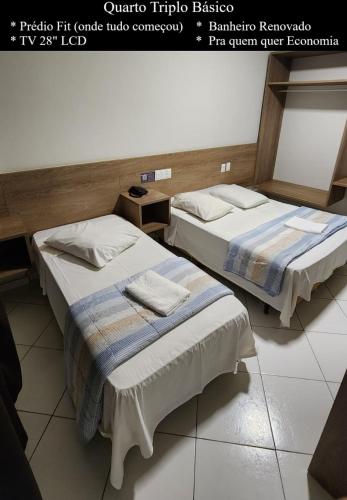 two beds sitting next to each other in a room at HOTEL CAMPO GRANDE in Campo Grande