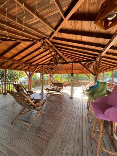 a deck with lounge chairs and a wooden ceiling at Reserva Natural Origen Alojamiento Campestre in San Rafael