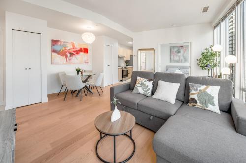 a living room with a couch and a table at Modern & Cozy Home in the Heart of Downtown Vancouver in Vancouver