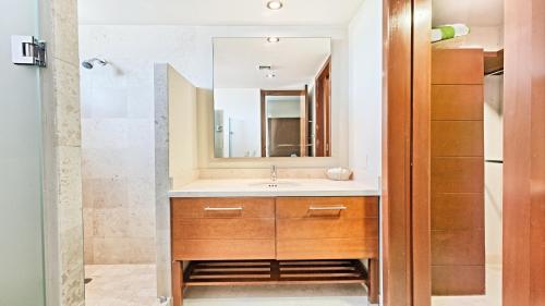 a bathroom with a sink and a mirror at Encanto Living Two Bedroom Unit by Kivoya in Puerto Peñasco