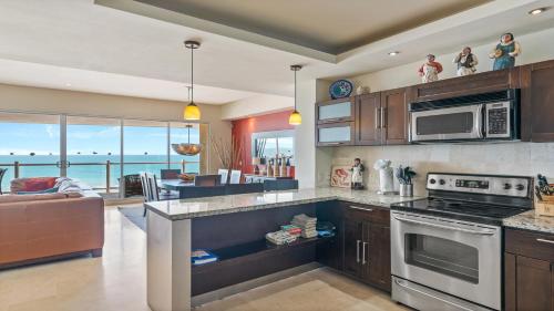 a kitchen with a view of the ocean at Encanto Living Two Bedroom Unit by Kivoya in Puerto Peñasco