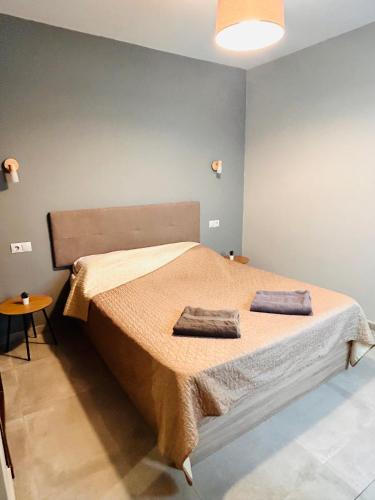 a bedroom with a large bed with two towels on it at Luxury Suites Fuengirola 2 in Fuengirola