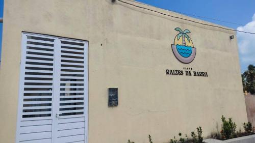 a building with a painting on the side of it at Flats Raízes da Barra in Maragogi