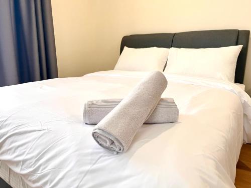 a rolled up towel on top of a bed at HillMark Suites in Ayer Keroh
