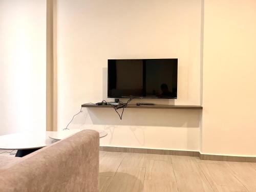 a living room with a flat screen tv on a wall at HillMark Suites in Ayer Keroh