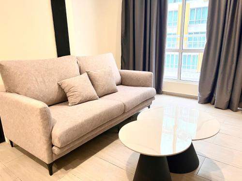 a living room with a couch and a table at HillMark Suites in Ayer Keroh