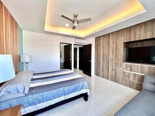 a bedroom with a bed and a ceiling fan at sunset view 1004 in Mazatlán