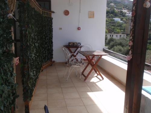 a balcony with a table and a view at Traditional Studio in Kalymnos
