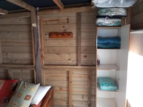 a small room with wooden walls and bunk beds at El Navegante in Cabo Polonio