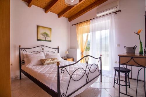 a bedroom with a bed and a window at Villa Marianna in Vryses