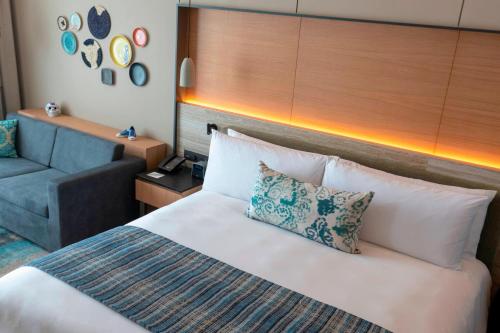 a hotel room with a bed and a couch at Renaissance Cancun Resort & Marina in Cancún