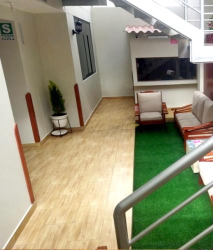 a living room with a couch and chairs in a building at Retama Lodging in Cusco