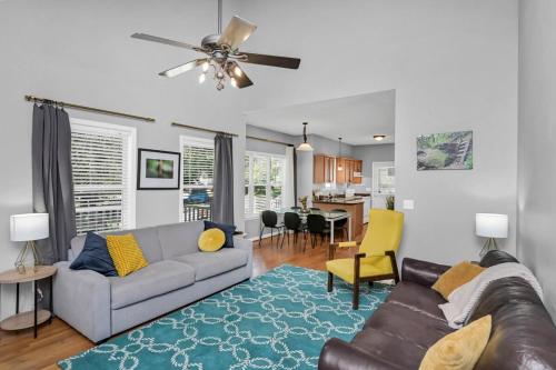 a living room with a couch and a dining room at Walk to Stadium in Columbia
