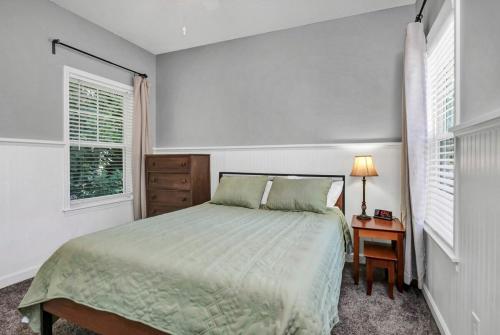 a bedroom with a bed and a table with a lamp at Walk to Stadium in Columbia