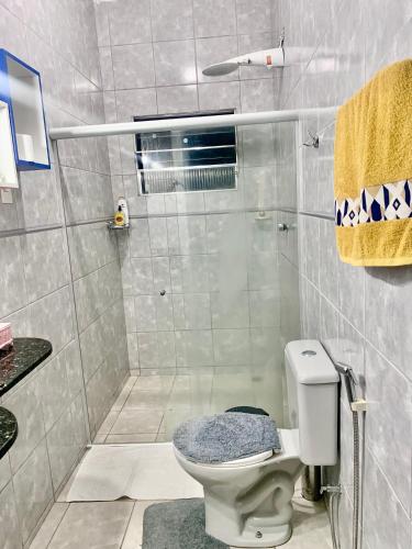 a bathroom with a toilet and a shower at Hospedagem Maceió in Maceió