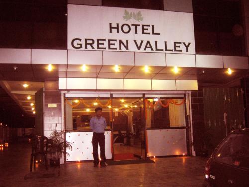 a man standing in front of a hotel green valley at Hotel Green Valley in Guwahati