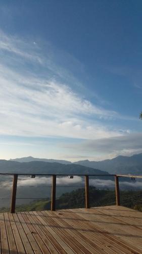 a wooden boardwalk with a view of the water at Reserva Natural Origen Alojamiento Campestre in San Rafael