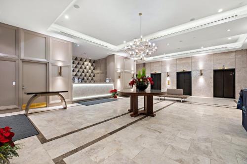 a large lobby with a table and a couch at Luxurious Suite in Yorkville in Toronto