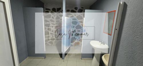 a bathroom with a shower with a toilet and a sink at Casa Memmar in Acapulco