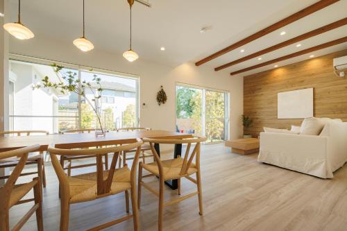 a kitchen and living room with a table and chairs at New Villa Natural J 伊豆高原 城ヶ崎海岸 in Ito