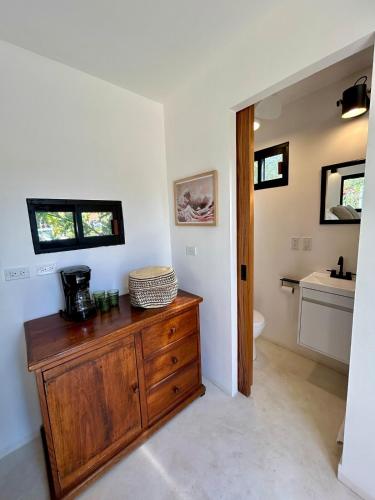 a bathroom with a wooden dresser and a sink at Casita Palo Verde in San José del Cabo