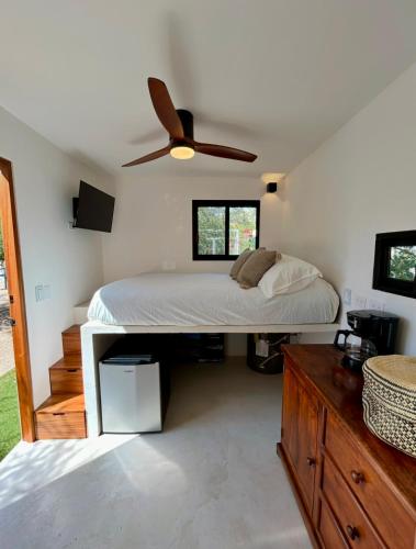 a bedroom with a bed with a ceiling fan at Casita Palo Verde in San José del Cabo