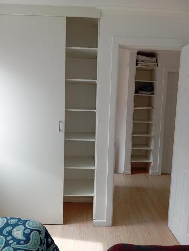 a room with a closet with shelves at Camila in Punta Arenas