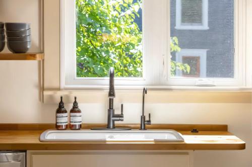 a sink in a kitchen with a window at The School House - Walk to all Shops and Restaurants - New Remodel in Manchester
