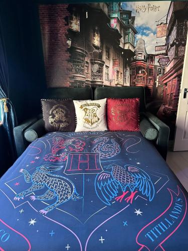 a bedroom with a bed with two peacocks painted on it at Hogwarts apartment in Abbots Langley