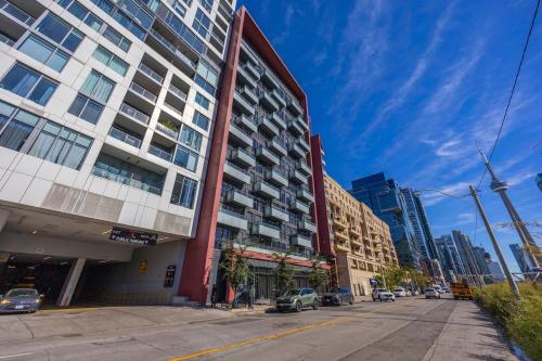 an empty street in a city with a tall building at Spectacular Suite in the Heart of Toronto in Toronto
