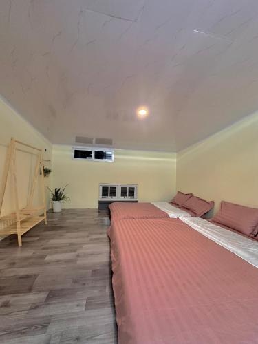 a large bedroom with two beds in a room at Hùng Nam House in Khu Chi Lăng