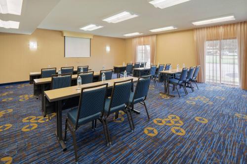 a conference room with tables and chairs and a whiteboard at Courtyard Dallas Addison Midway in Addison