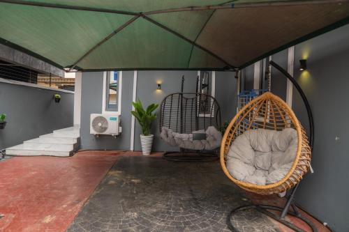 a porch with two chairs under a tent at 4 Bedroom Luxe Living- Magodo Phase 1 - 247 POWER in Magodo