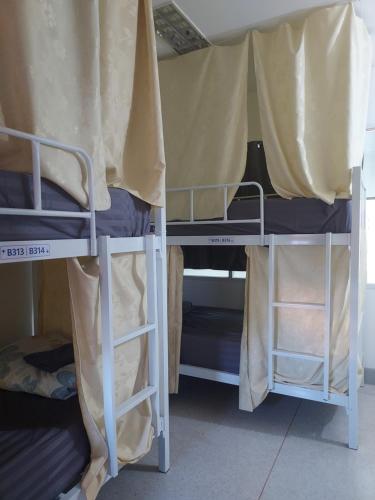 a group of bunk beds in a room at KingSun HOSTEL 金珊旅馆 in Chiang Rai