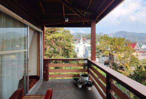 a balcony with a view of a city at RedDoorz @ Monterrazas Village Homestay Baguio in Baguio