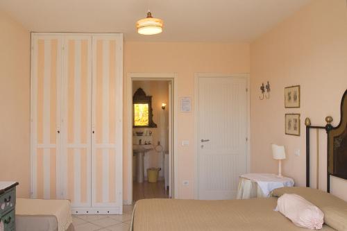 a bedroom with two beds and a clock on the wall at Villa Amelia Rooms in Marina di Pietrasanta